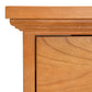 A close up of a Lyndon Furniture Shaker 2-Drawer Vertical File Cabinet made of cherry wood.