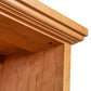 Close-up of Lyndon Furniture Shaker Bookcase corner in natural finish, highlighting detailed molding and quality Vermont craftsmanship.