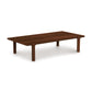 A simple Copeland Furniture Sierra Rectangular Coffee Table made of solid North American hardwood with four legs on a plain background.