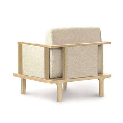 The Copeland Furniture Sierra Oak Upholstered Chair with Upholstered Panels features an elegant wooden frame and is adorned with a beige fabric upholstery.