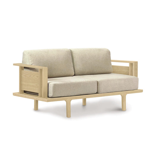 A contemporary design Copeland Furniture Sierra Oak Upholstered Loveseat with beige cushions on a white background.