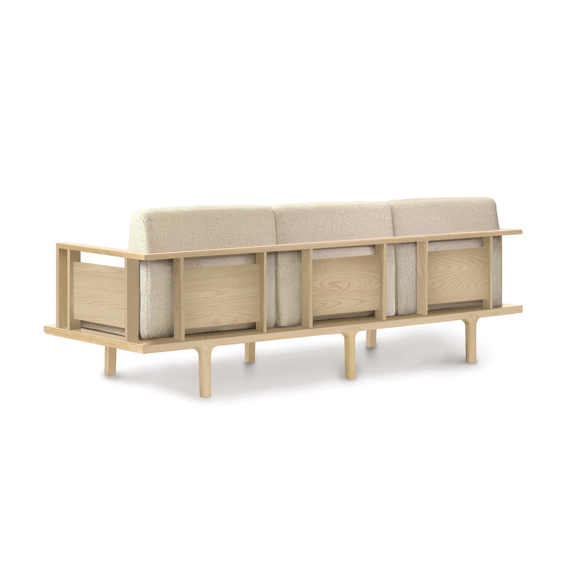 A contemporary Copeland Furniture Sierra Oak Upholstered Sofa with beige cushions and side storage compartments, isolated on a white background.