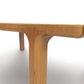 A wooden Copeland Furniture Sierra Square Coffee Table with a contemporary design, featuring wooden top and legs.