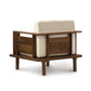 A Copeland Furniture Sierra Walnut Upholstered Chair with a solid wood frame and a white cushion.