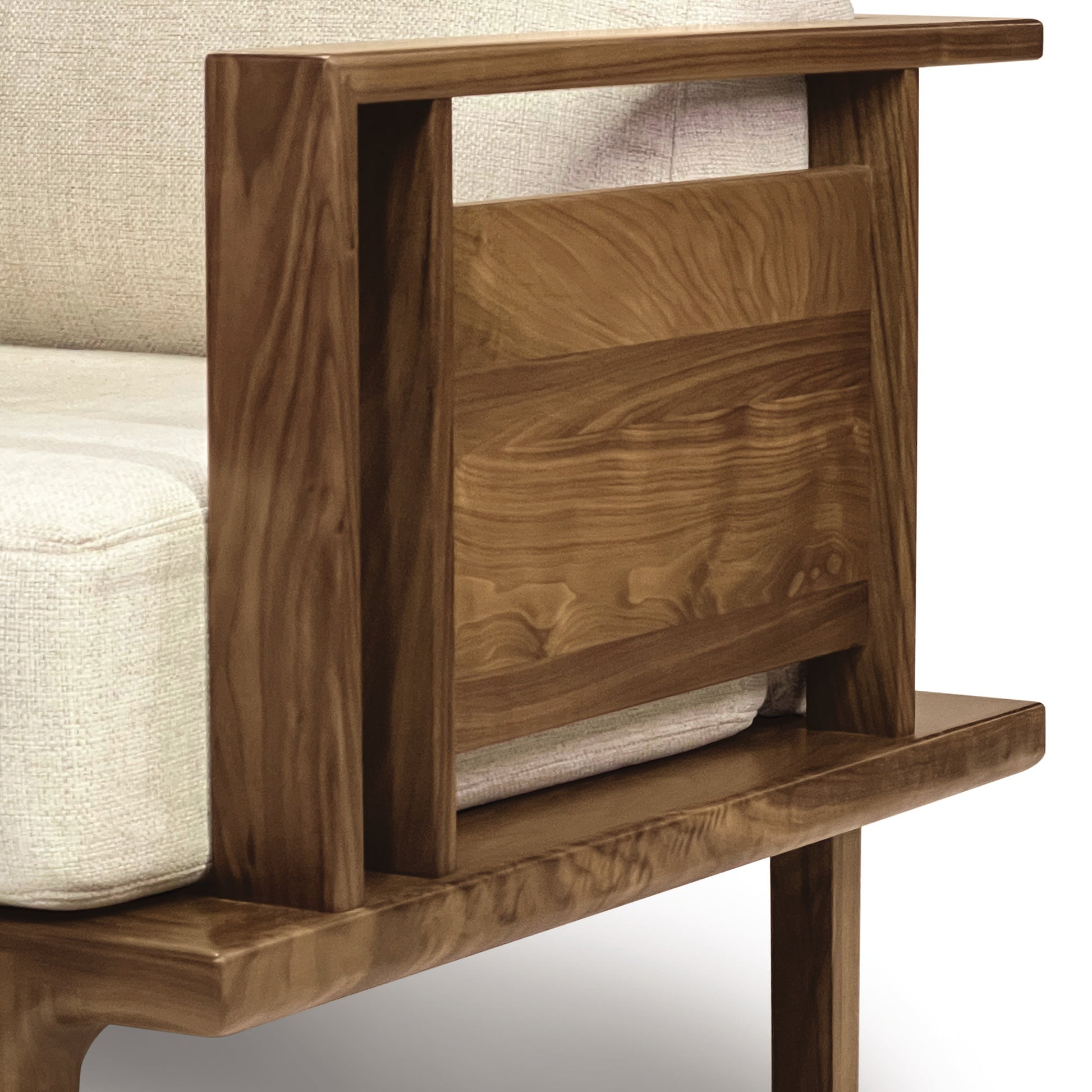 A close-up of a walnut side table with an open lower shelf, adjacent to a light-colored Copeland Furniture Sierra Walnut Upholstered Chair.