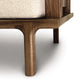 A close-up of a Copeland Furniture Sierra Walnut Upholstered Chair leg and part of the seat, highlighting the wood grain and construction details.