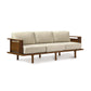 A Sierra Walnut Upholstered Sofa by Copeland Furniture, with a wooden frame and upholstered beige cushions.