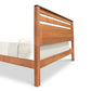 The Vermont Furniture Designs Skyline Panel Bed is a handmade-to-order wooden bed frame with a slatted headboard, featuring a natural eco-friendly hand-rubbed oil finish.
