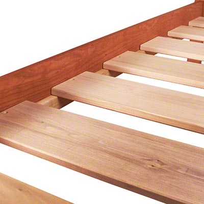 A wooden bed frame with wooden slats.