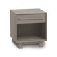 Sloane Nightstand by Copeland Furniture made of natural hardwood, featuring a sleek metal handle and an open shelf.