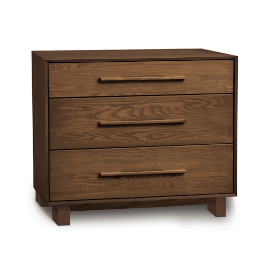 The Copeland Furniture Sloane 3-Drawer Chest combines contemporary design with ample storage space. This wooden chest of drawers is showcased on a white background.