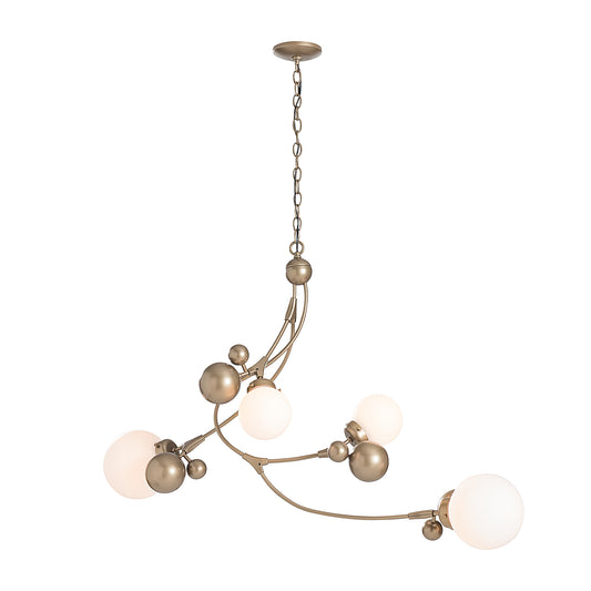 The Hubbardton Forge Sprig Pendant is a stunning piece of designer lighting, featuring four glass balls delicately hanging from a luxurious gold chain.