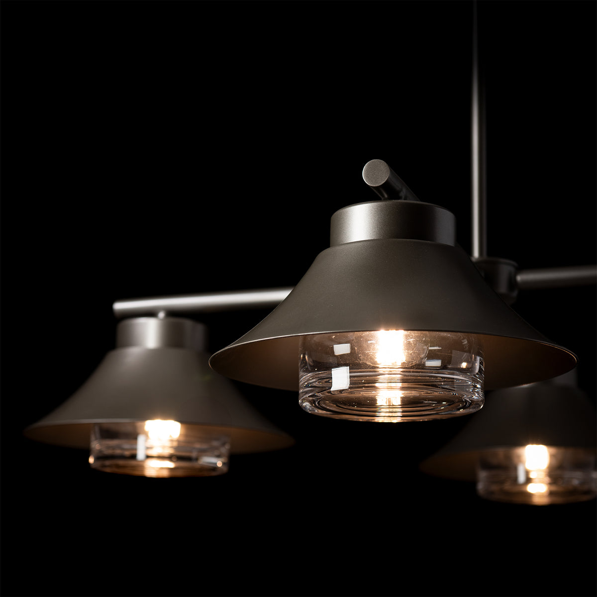 Stowe Outdoor 4-Light Pendant, a hand-forged steel fixture with four conical shades and clear glass diffusers.