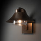 Stowe Outdoor Sconce featuring hand-forged steel, a wide shade, and a clear glass light diffuser.
