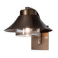 Stowe Outdoor Sconce in dark bronze, featuring a handcrafted steel frame with a wide shade and clear glass-encased light.
