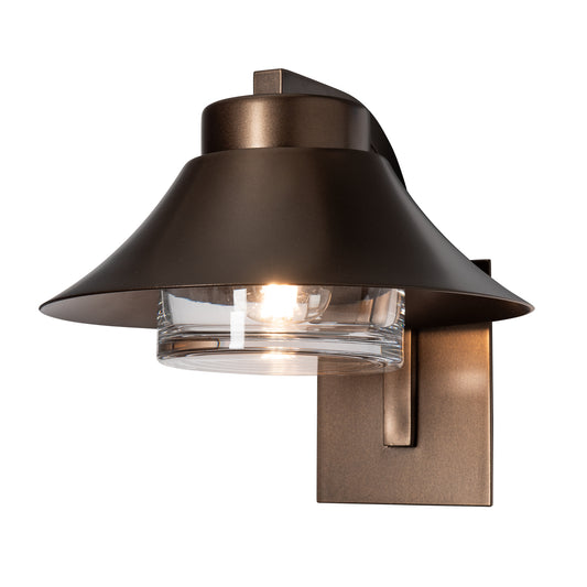 Stowe Outdoor Sconce in dark bronze, featuring a handcrafted steel frame with a wide shade and clear glass-encased light.
