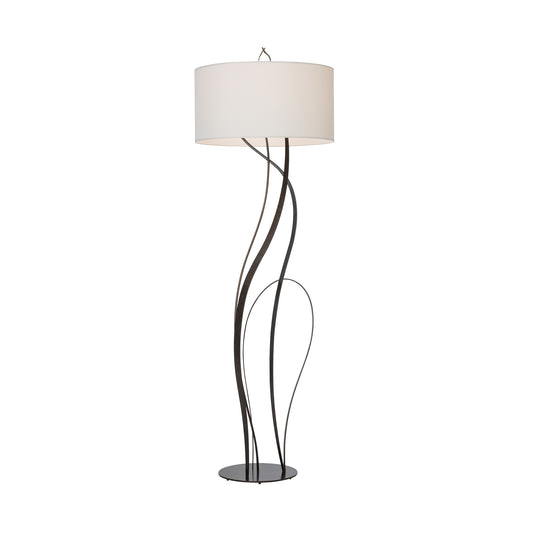 Hubbardton Forge Sway Floor Lamp featuring a round white shade and hand-forged steel base, crafted in America for elegant modern interiors.