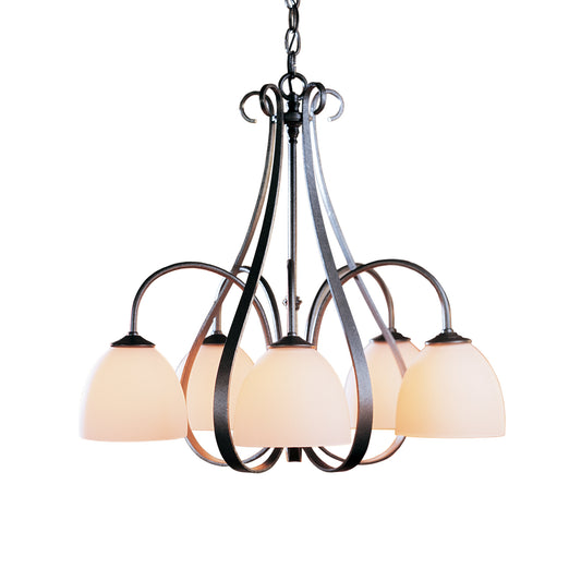 A Sweeping Taper 5-Arm Chandelier with frosted glass shades, perfect for a dining area, made by Hubbardton Forge.