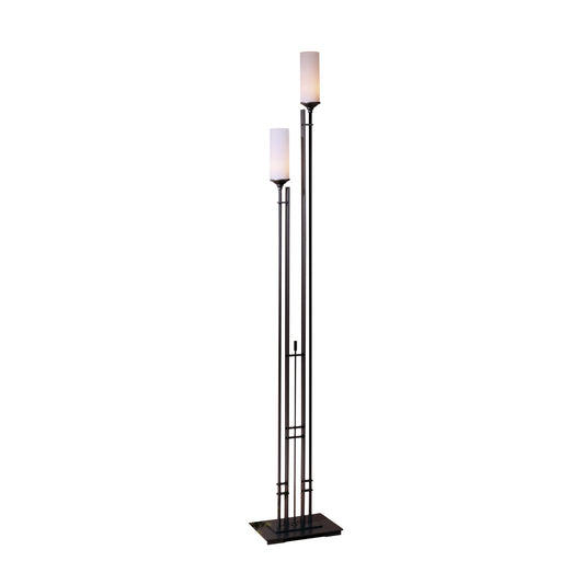 The Hubbardton Forge Tall Metra Twin Floor Lamp features a sleek black design complemented by a stylish white shade, enhancing any room's lighting ambiance.
