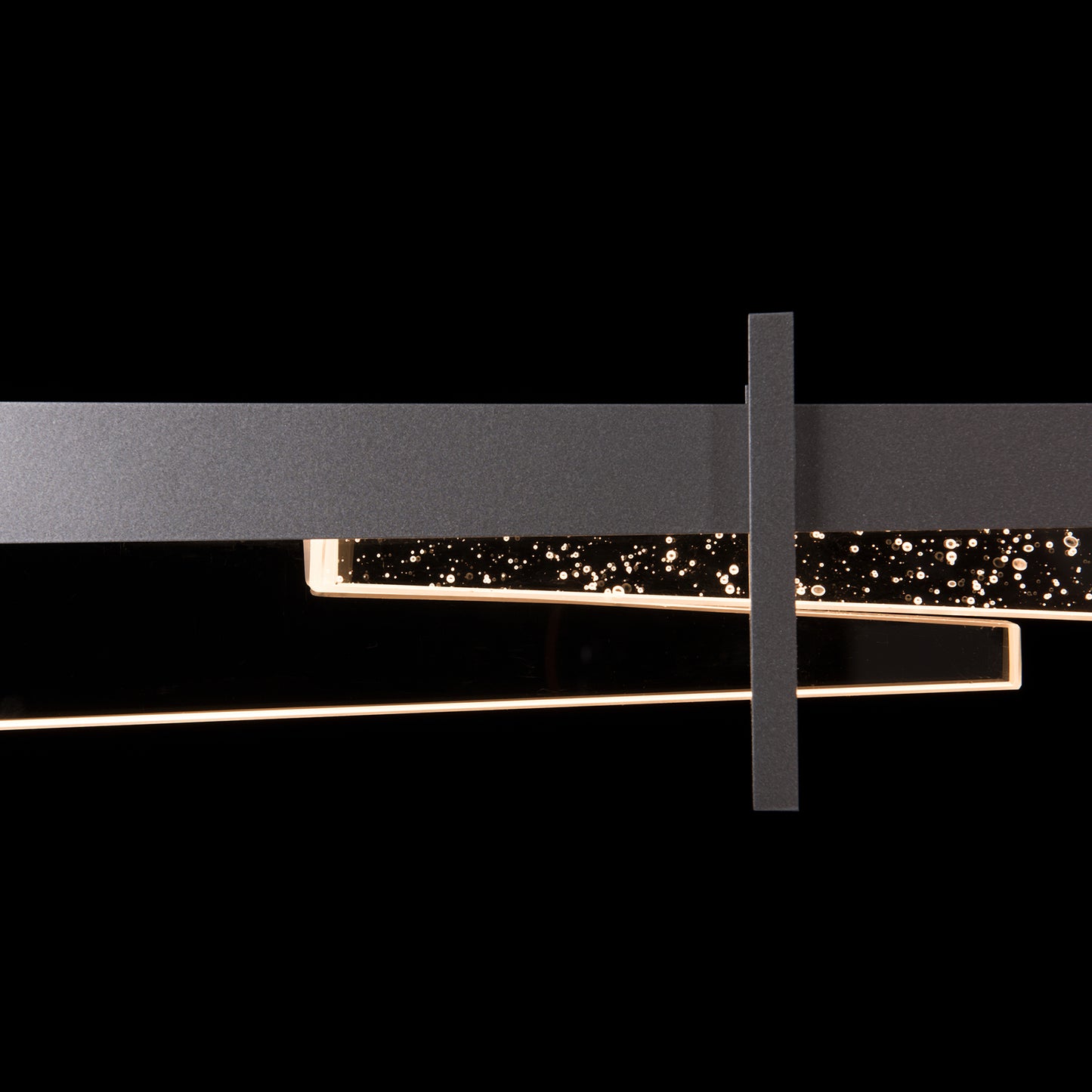 A handcrafted Tenon LED pendant light fixture with a black frame and stars on it, by Hubbardton Forge lighting.