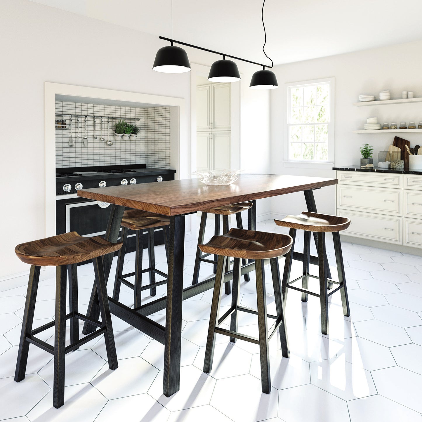 A modern kitchen features Copeland Furniture's Modern Farmhouse Counter Height Farm Table made of solid hardwood, with seared oak trestle-style legs and four matching stools. The space includes white cabinetry, a black stove, and a white hexagonal-tile floor. Three black pendant lights hang above the table, while a window allows natural light to enter.