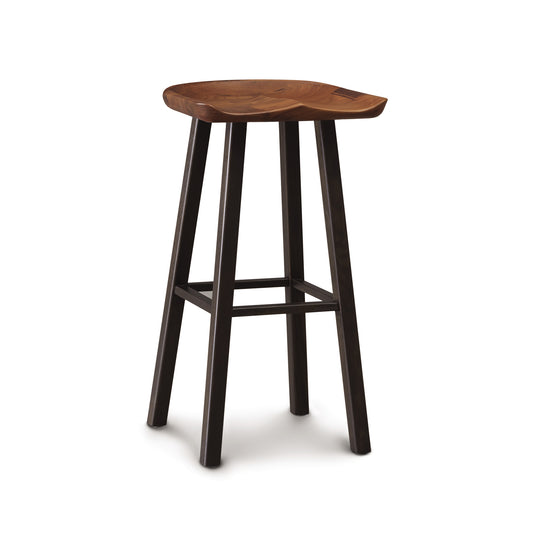 A bar stool with a wooden seat and black legs.