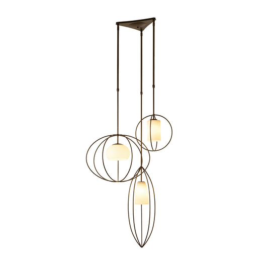 Three handcrafted Hubbardton Forge Treble Pendant light fixtures suspended from a ceiling.