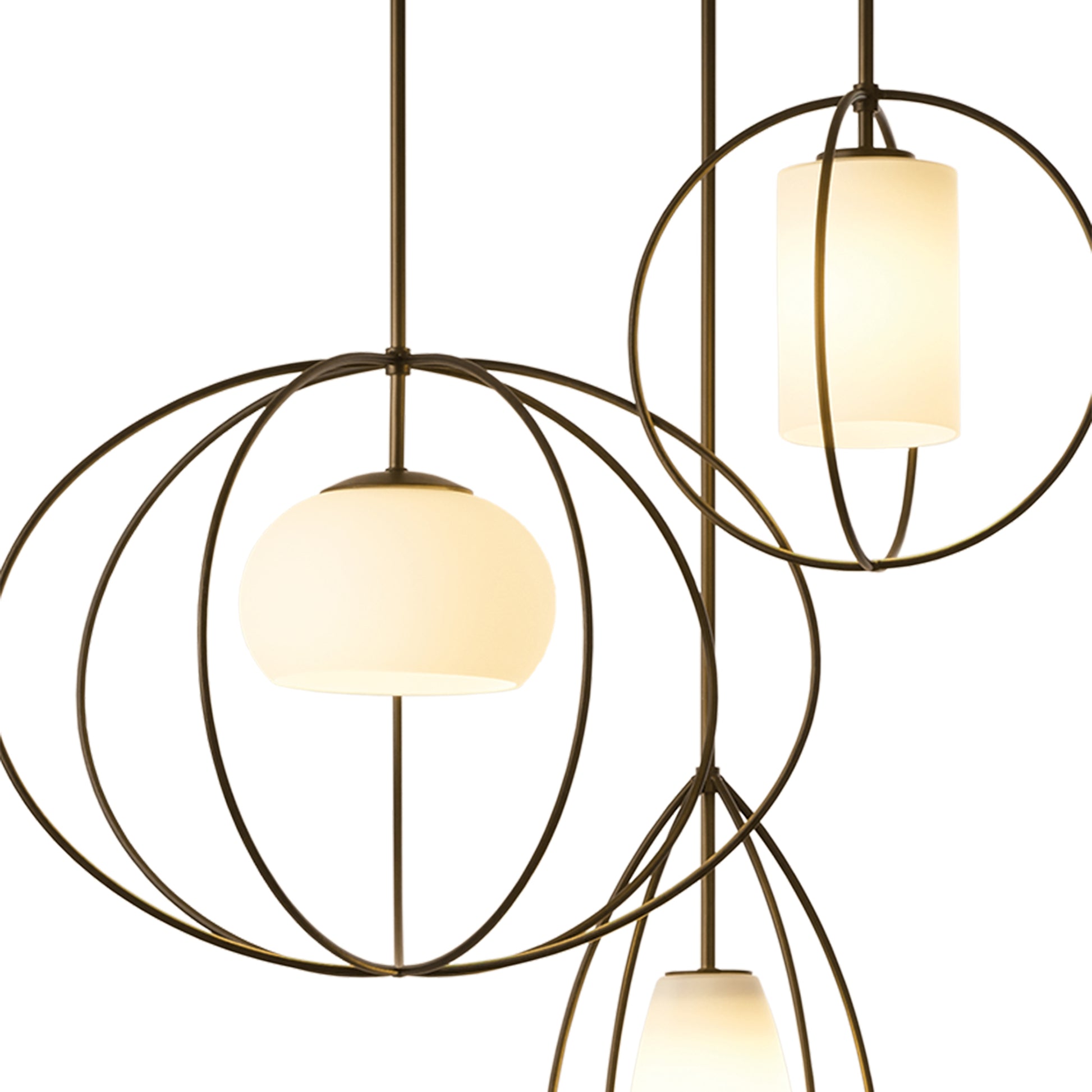 Three Hubbardton Forge Treble Pendant lighting fixtures hanging from a ceiling.