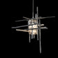 Close-up of the Tura Seeded Glass Low Voltage Mini Pendant by Hubbardton Forge, highlighting its modern geometric glass and intersecting metal rods.