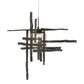 The Tura Seeded Glass Low Voltage Mini Pendant by Hubbardton Forge with intersecting metal bars and textured seeded glass accentuates quality American craftsmanship.