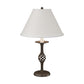 Twist Basket Table Lamp by Hubbardton Forge with a handcrafted bronze twisted base and white shade, showcasing fine American craftsmanship.