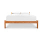 Vergennes Platform Bed with eco-friendly hardwood solid wood frame and a white mattress and pillows.