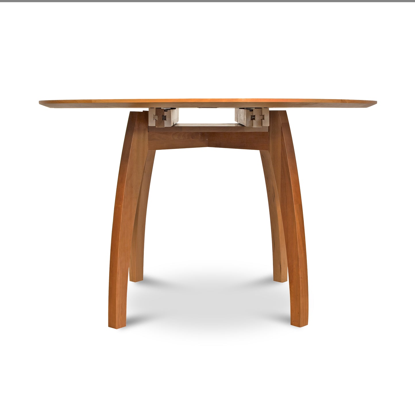 Vermont Modern Round Pedestal Extension Table from solid wood with elegantly curved legs by Lyndon Furniture.