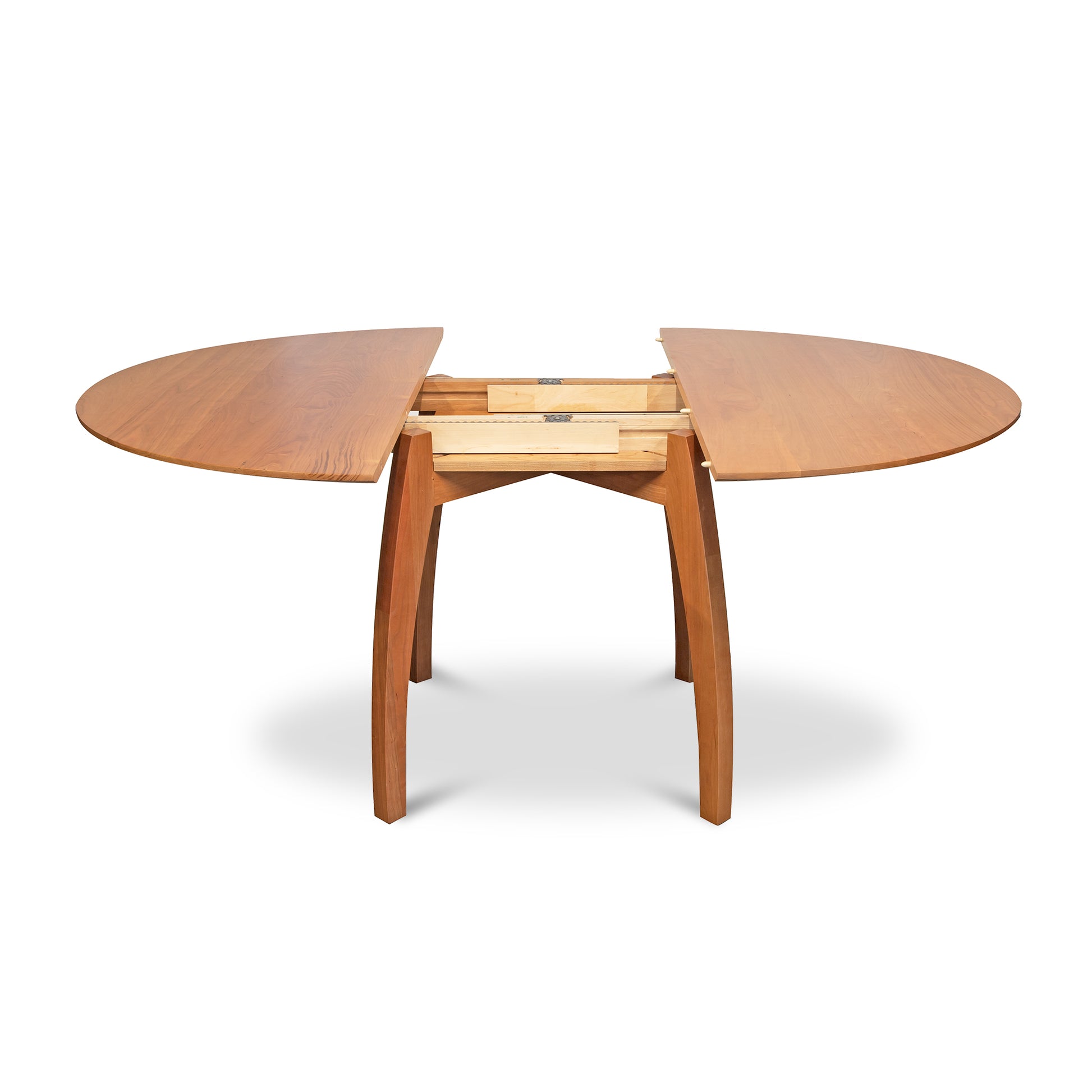 Vermont Modern Round Pedestal Extension Table in solid wood with extended leaves and visible extension mechanism by Lyndon Furniture.