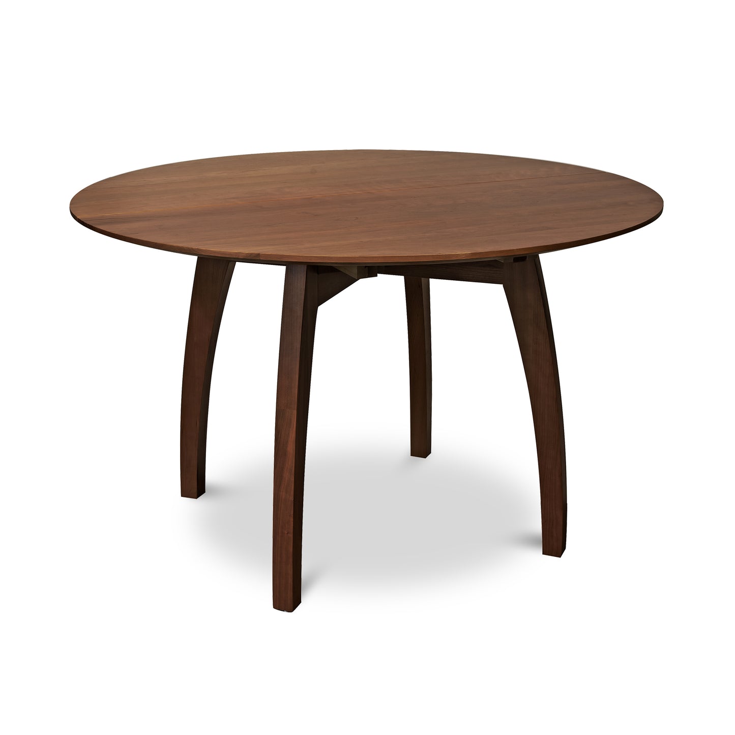 Vermont Modern Round Pedestal Extension Table with dark brown finish and elegantly curved four-leg design by Lyndon Furniture.