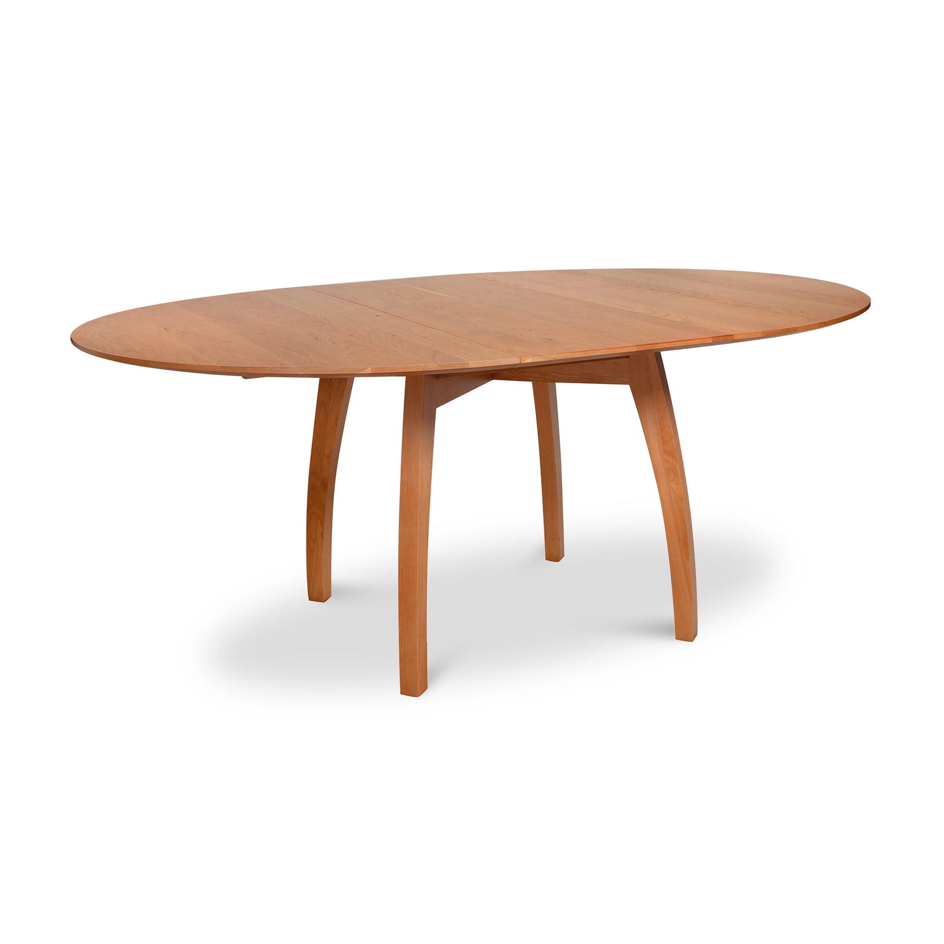 Oval solid wood dining table with center leaf and four curved legs in Vermont Modern Round Pedestal style by Lyndon Furniture.