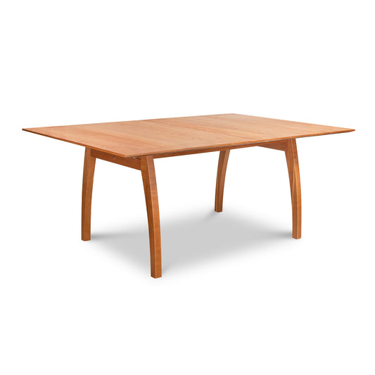 Lyndon Furniture Vermont Modern Extension Trestle Table with solid cherry rectangular top and four curved legs.