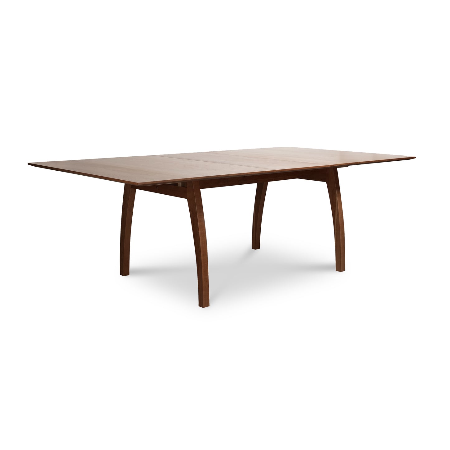 Dark brown solid wood Vermont Modern Extension Trestle Table by Lyndon Furniture featuring a rectangular top and elegantly curved legs.