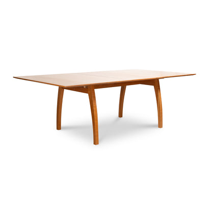 Vermont Modern Extension Trestle Table in solid cherry with elegant curved legs by Lyndon Furniture.