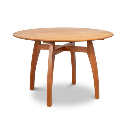 A Lyndon Furniture Vermont Modern Round Solid Top Pedestal Table, handcrafted with organic wood, featuring a round shape and two sturdy legs supporting the beautiful wooden top.