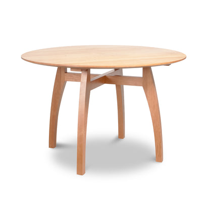 Vermont Modern Round Solid Top Pedestal Table by Lyndon Furniture with four curved legs and a light natural wood finish.