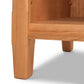 Close-up of a Vermont Shaker 1-Drawer Enclosed Shelf Nightstand by Maple Corner Woodworks, focusing on the detail of the seat and leg junction, with a smooth finish and visible wood grain.