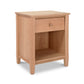 A light natural cherry Vermont Shaker 1-Drawer Enclosed Shelf Nightstand by Maple Corner Woodworks featuring a smooth top, a single drawer with a round knob, and an open lower shelf, isolated on a white background.