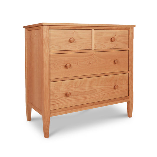 A Vermont Shaker 4-Drawer Chest with round knobs, made of solid cherry wood from Maple Corner Woodworks, isolated on a white background.
