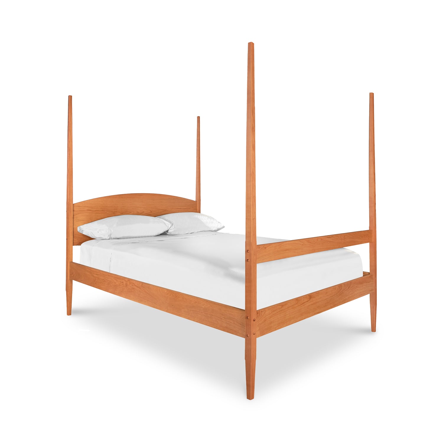 Vermont Shaker Four Poster Bed by Maple Corner Woodworks, showcasing its solid wood craftsmanship and subtly curved headboard, accompanied by a white sheet and two pillows.