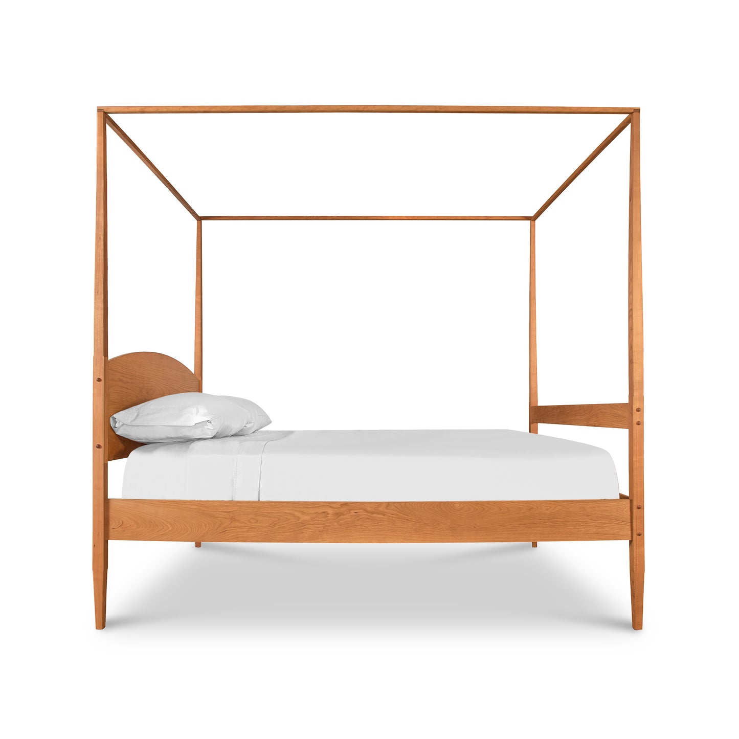 A modern Vermont Shaker Four Poster Bed with Canopy made of light oak wood, featuring a minimalist frame, with a single white pillow and a white mattress, isolated on a white background. (Brand: Maple Corner Woodworks)