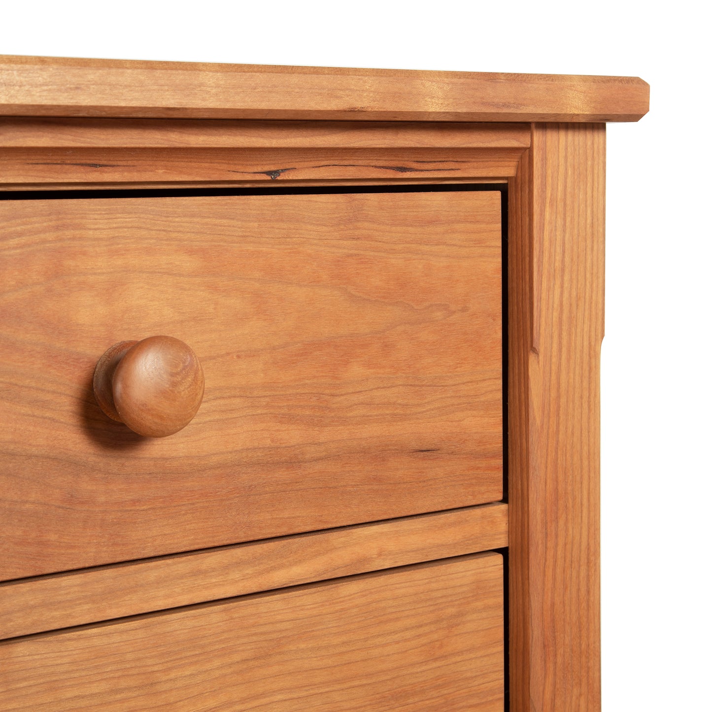 Handcrafted hardwood dresser showcasing two drawers with round knobs, highlighting the intricate wood grain and corner details of the Vermont Shaker 6-Drawer Chest by Maple Corner Woodworks, perfect for elegant bedroom storage.