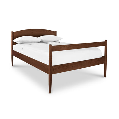 Vermont Shaker Bed by Maple Corner Woodworks featuring a minimalist wooden frame with white bedding and two pillows, captured from an angled perspective