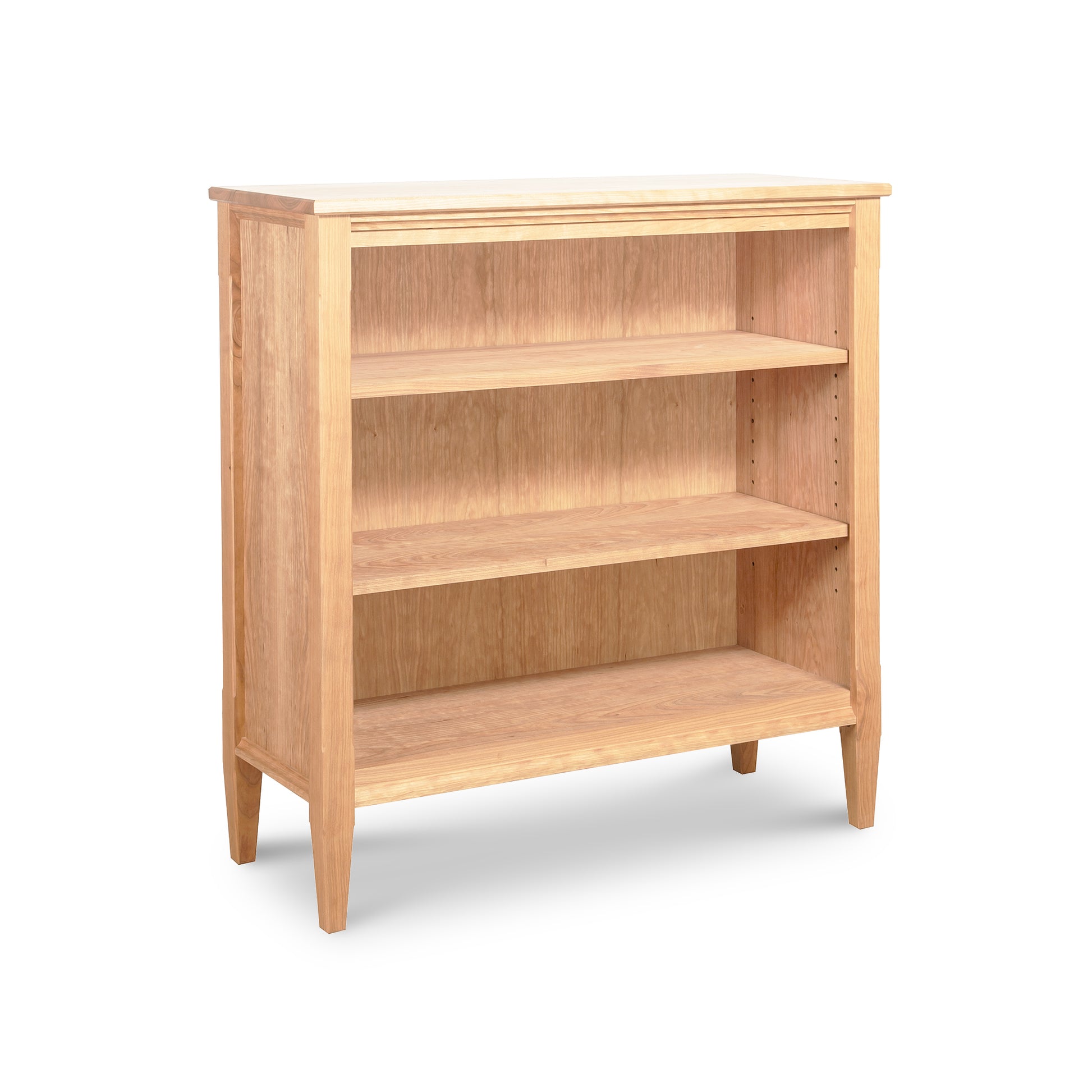 Vermont Shaker Bookcase by Maple Corner Woodworks, showcasing a light natural finish with three adjustable shelves crafted from sustainably harvested hardwoods.