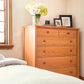 Maple Corner Woodworks Vermont Shaker Extra Wide Chest in solid wood, expertly crafted and positioned as the focal point beside the bed.